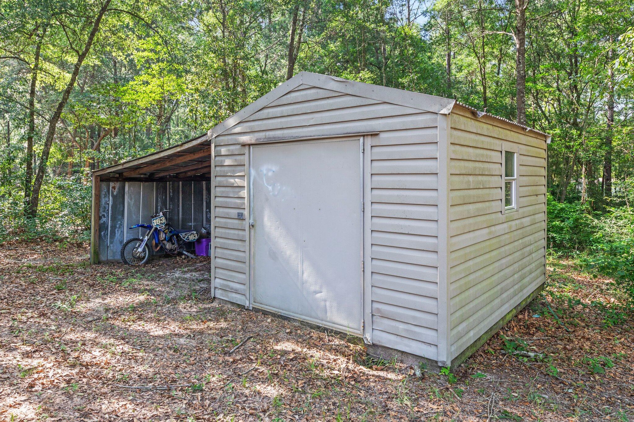 3943 Bambi Road Crestview, FL 32539 - Photo 31 of 36 a view of a house with a yard and garage