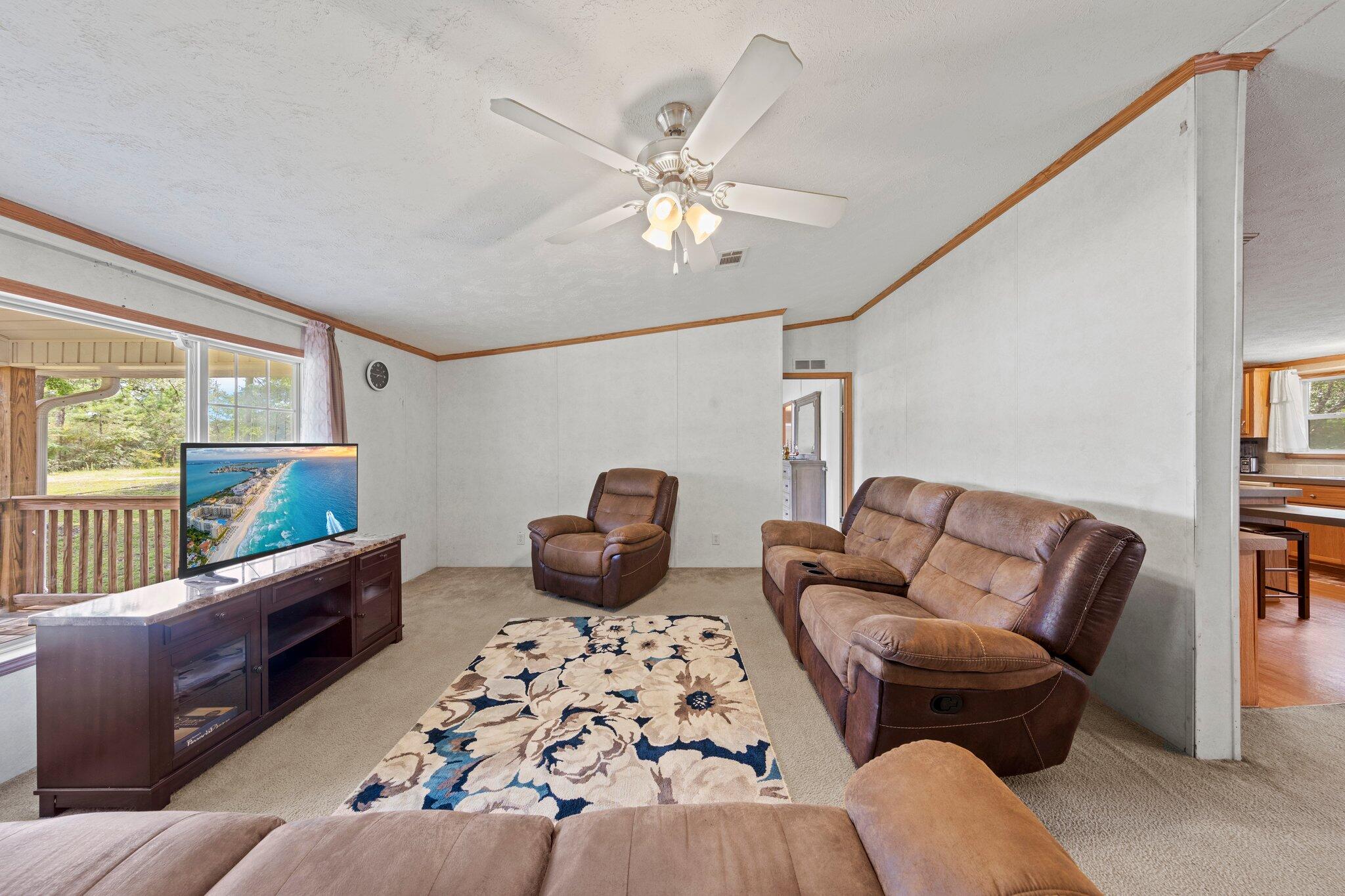 3943 Bambi Road Crestview, FL 32539 - Photo 4 of 36 a living room with furniture ceiling fan and a window