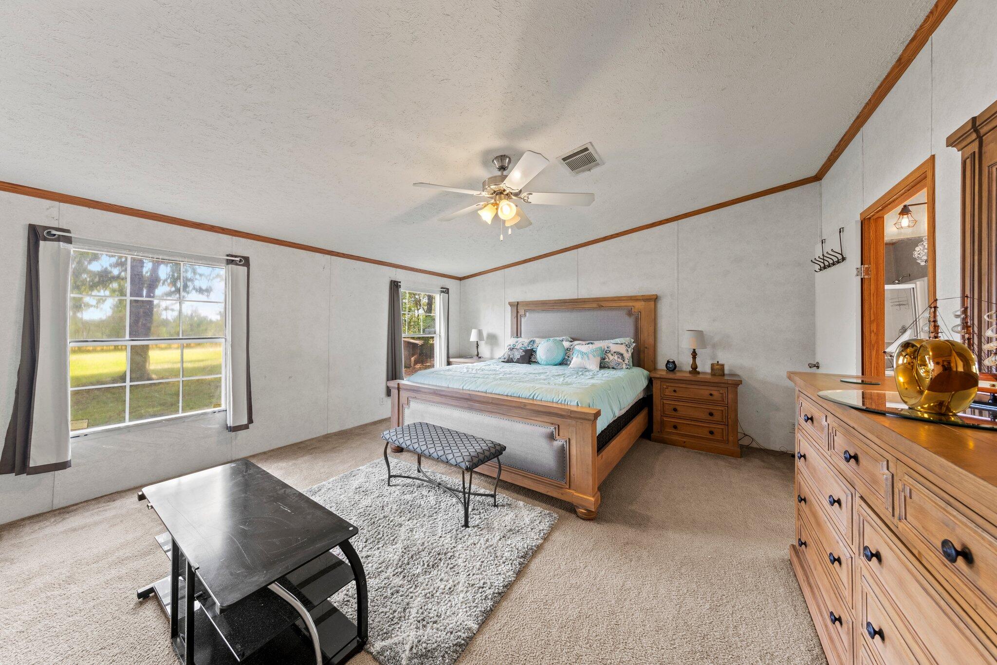 3943 Bambi Road Crestview, FL 32539 - Photo 7 of 36 a bedroom with a bed a table and chair