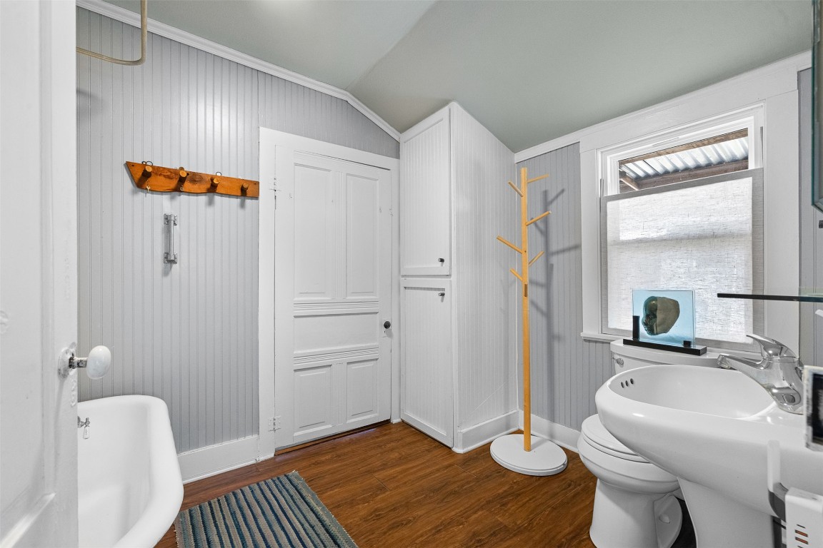 660 North Main Street La Grange, TX 78945 - Photo 12 of 24 Bathroom with dark wood-style flooring, a soaking tub, and lofted ceiling