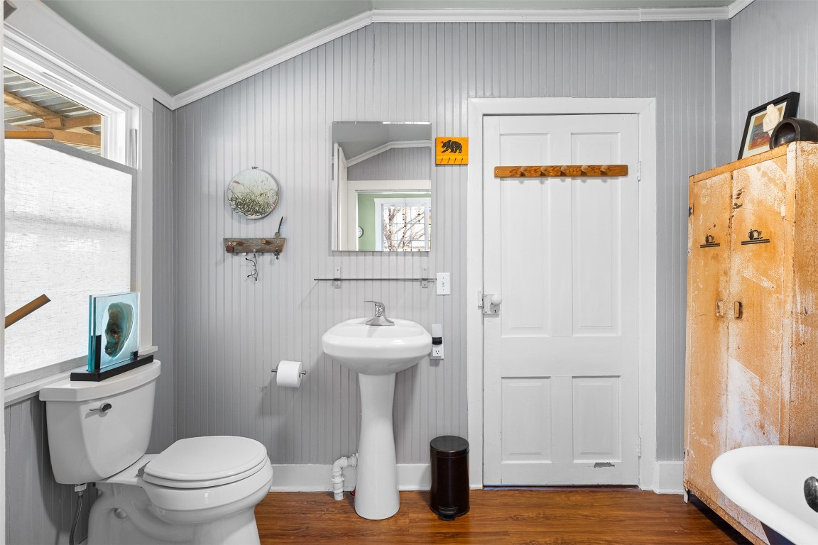 660 North Main Street La Grange, TX 78945 - Photo 14 of 24 Bathroom with healthy amount of natural light, lofted ceiling, dark wood finished floors, and ornamental molding