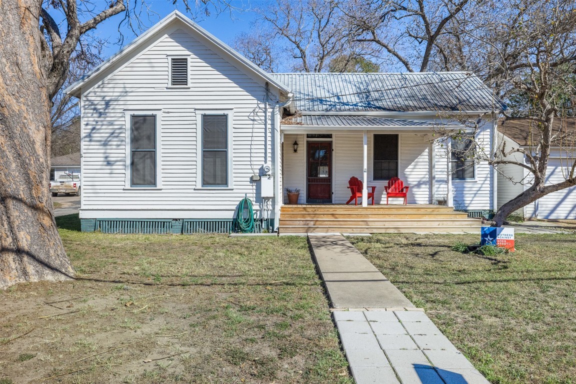 660 North Main Street La Grange, TX 78945 - Photo 2 of 24 View of front of home featuring a front lawn, covered porch, and a metal roof