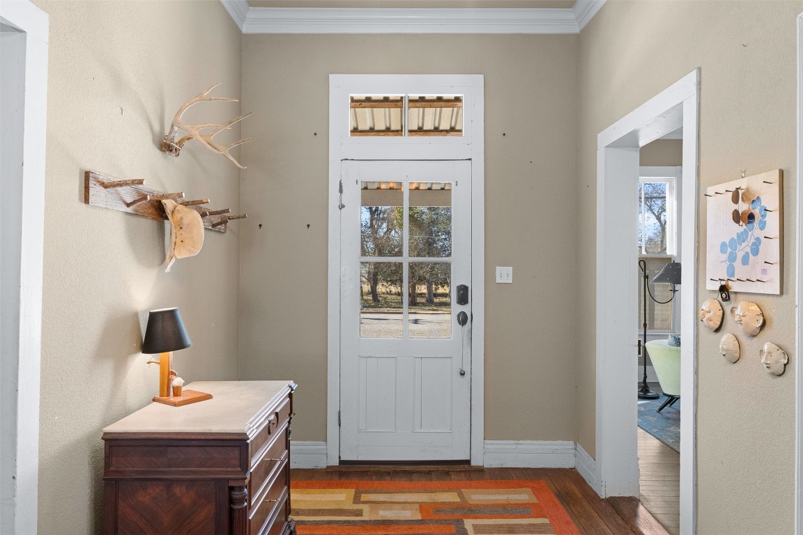 660 North Main Street La Grange, TX 78945 - Photo 5 of 24 Entrance foyer featuring wood finished floors, crown molding, and plenty of natural light