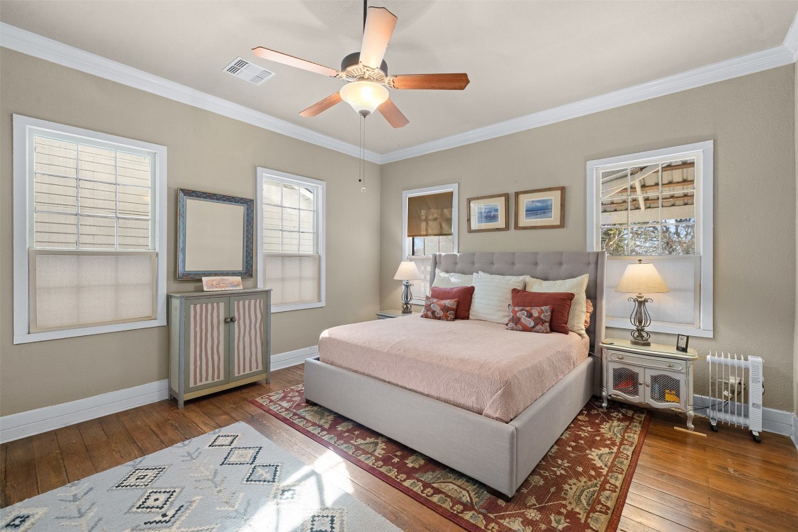 660 North Main Street La Grange, TX 78945 - Photo 6 of 24 Bedroom featuring wood-type flooring, ornamental molding, radiator, and ceiling fan