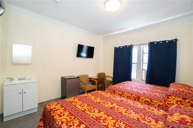 a bedroom with a bed and a flat screen tv