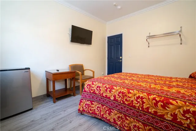 a bedroom with a bed and a flat screen tv