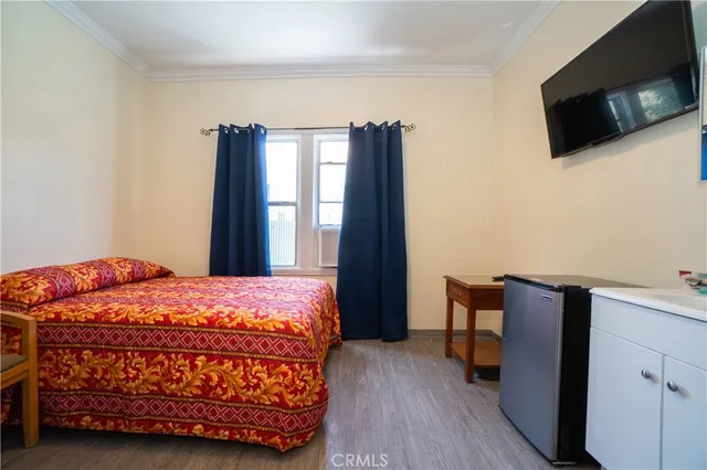 a bedroom with a bed and flat screen tv