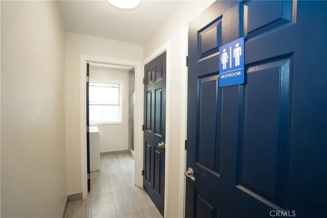 a view of a hallway with wooden shelves
