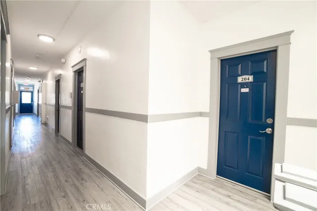 a view of hallway with wooden floor