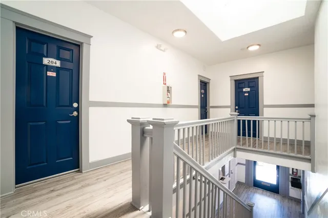 a view of staircase with railing and white walls