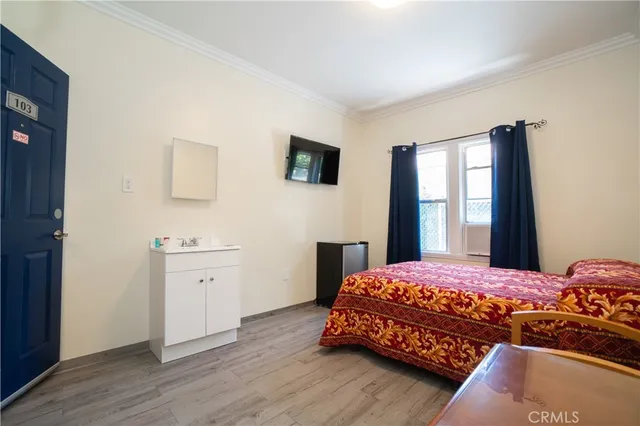 a bedroom with a bed and a flat screen tv