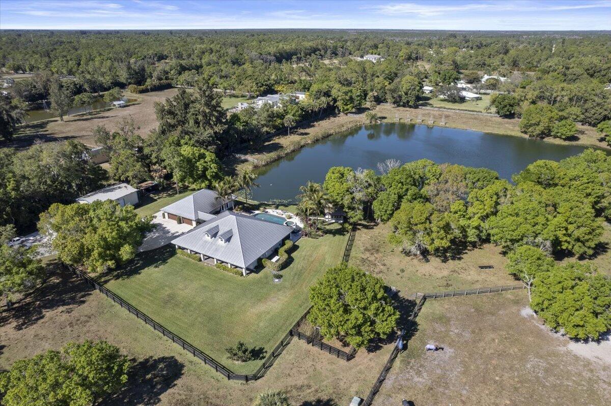 10975 Randolph Siding Road Jupiter, FL 33478 - Photo 91 of 97 an aerial view of a house with a garden and lake view