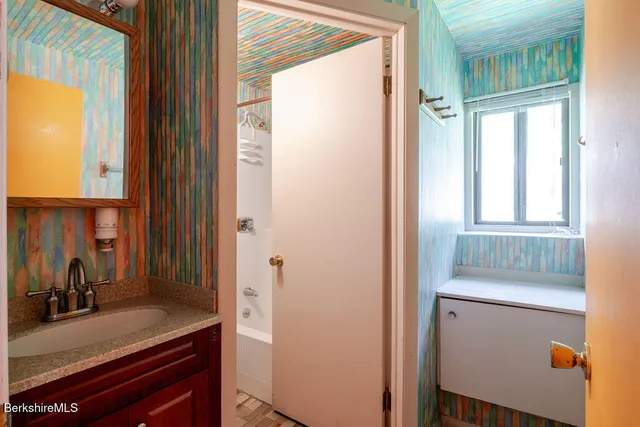 a view of a room that has a bed and a dresser