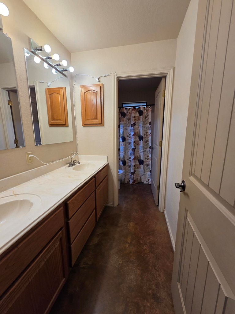 237 Green Oaks Loop Fredericksburg, TX 78624 - Photo 12 of 19 a spacious bathroom with a double vanity sink a and mirror