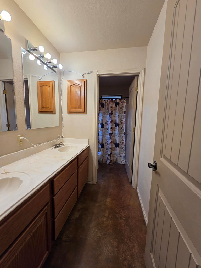 237 Green Oaks Loop Fredericksburg, TX 78624 - Photo 14 of 19 a bathroom with a double vanity sink a and mirror