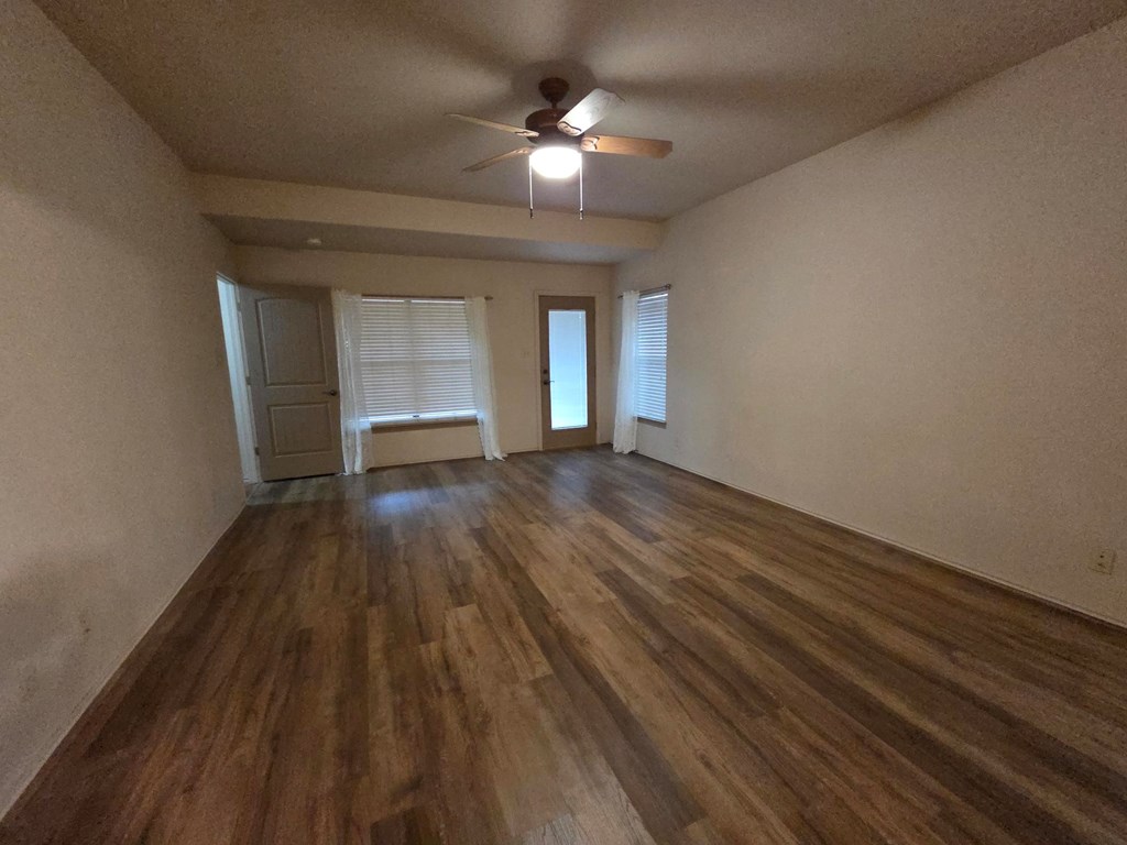 237 Green Oaks Loop Fredericksburg, TX 78624 - Photo 18 of 19 wooden floor in an empty room with a window