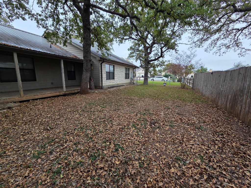 237 Green Oaks Loop Fredericksburg, TX 78624 - Photo 4 of 19 a backyard of a house with lots of green space
