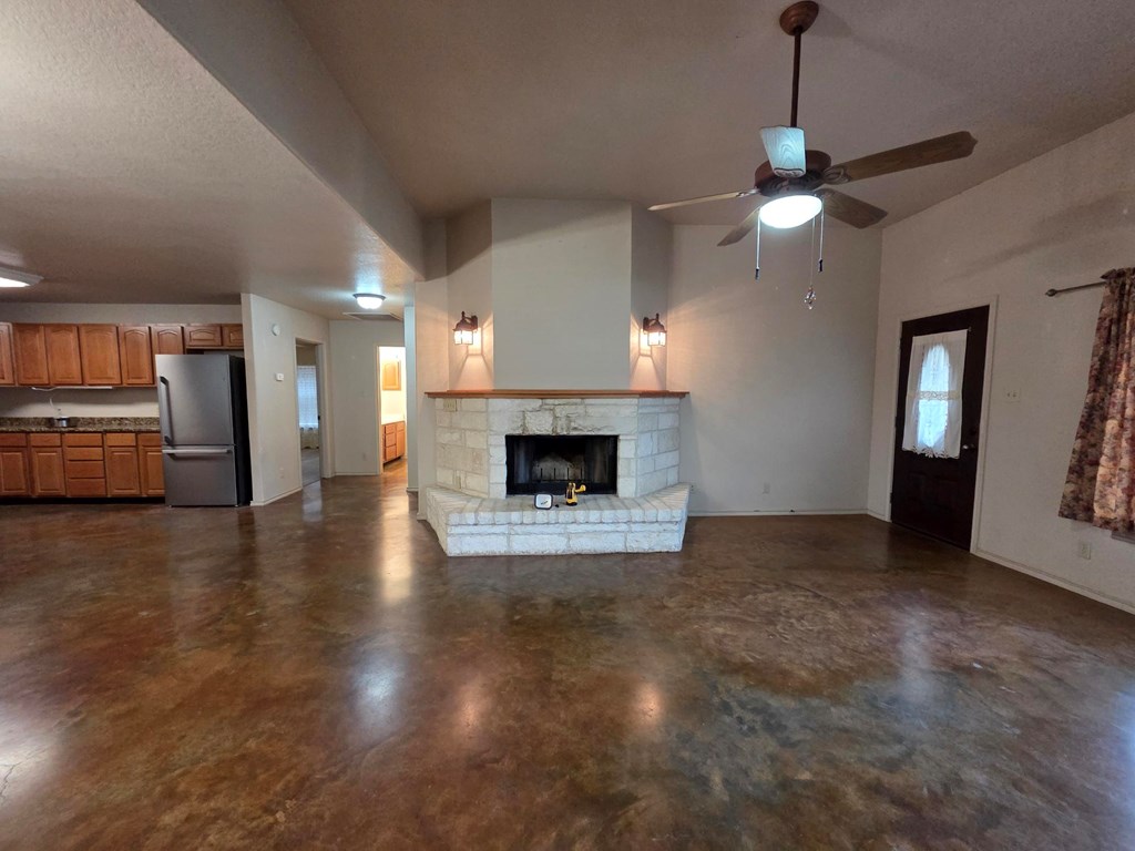 237 Green Oaks Loop Fredericksburg, TX 78624 - Photo 8 of 19 a view of a livingroom with a fireplace a chandelier and wooden floor