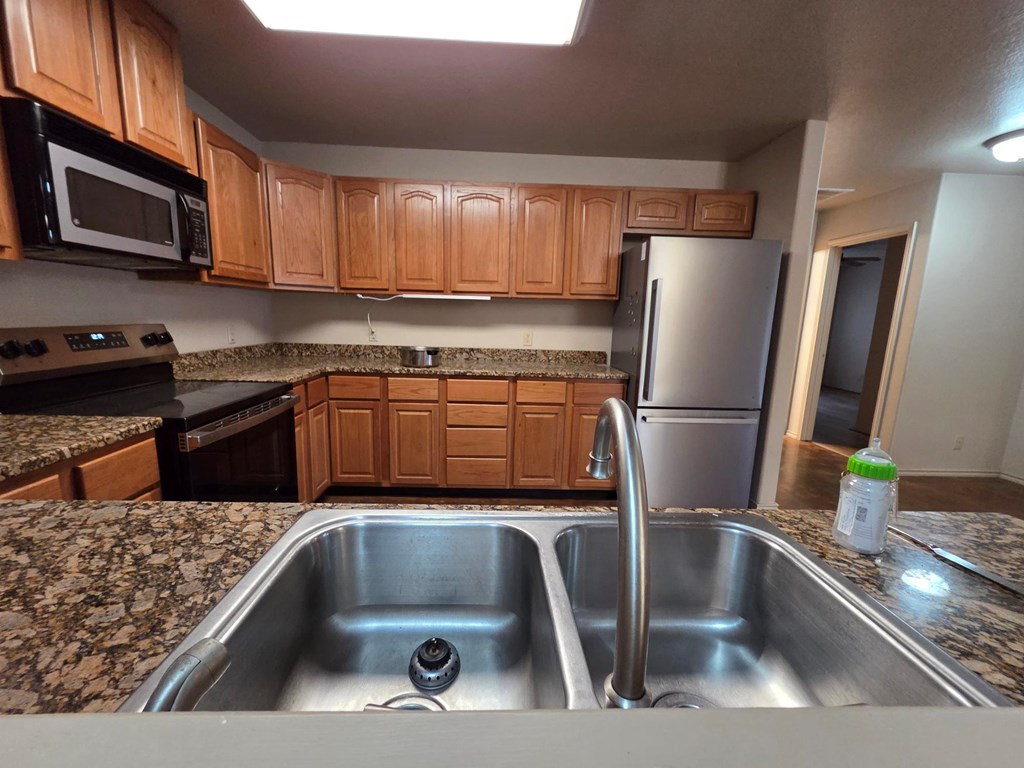 237 Green Oaks Loop Fredericksburg, TX 78624 - Photo 10 of 19 a kitchen with a refrigerator sink and microwave