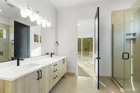 a bathroom with a double vanity sink and mirror