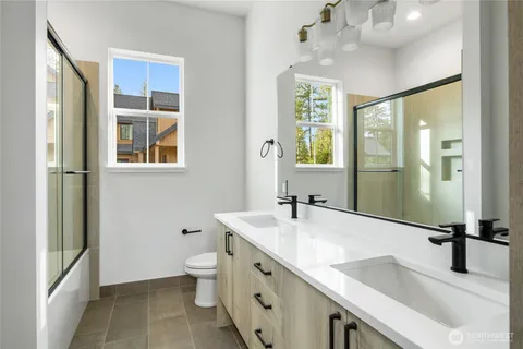 a bathroom with a sink double vanity and a shower