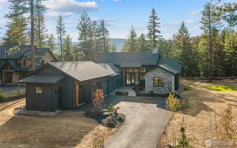 a view of a house with backyard and sitting area