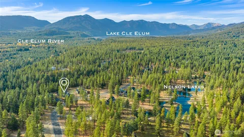 a view of a lush green hillside and houses