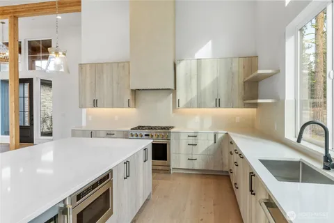 a kitchen with a stove a sink and a refrigerator