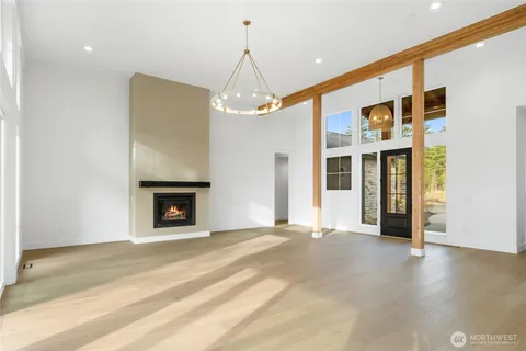 a view of an empty room with a fireplace and a window