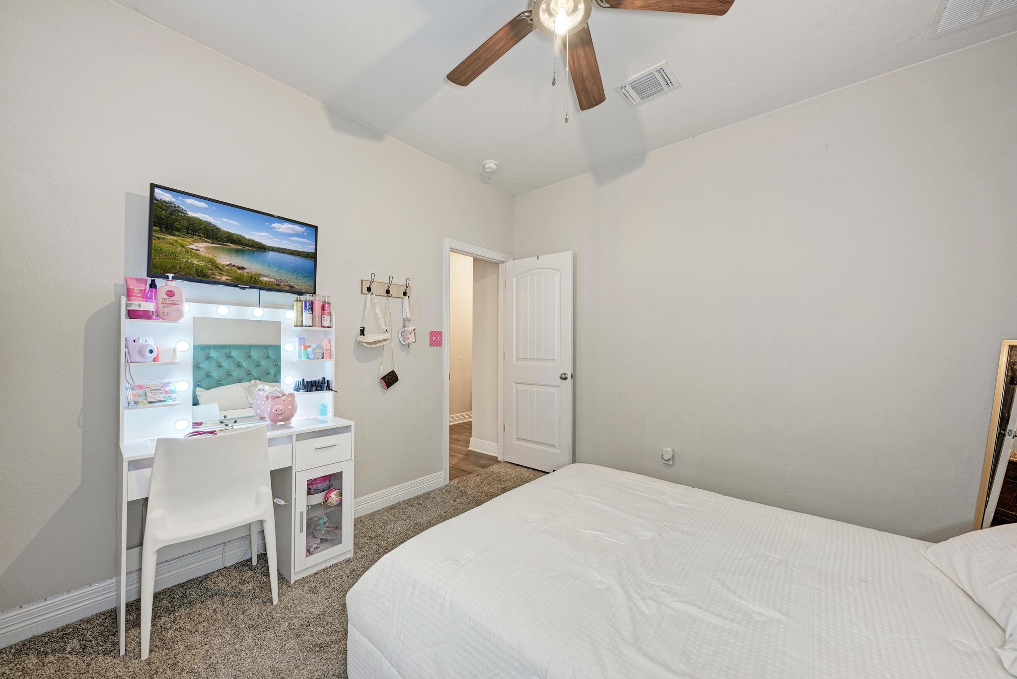 198 Rough Leaf Drive Buda, TX 78610 - Photo 22 of 38 Bedroom featuring carpet and a ceiling fan
