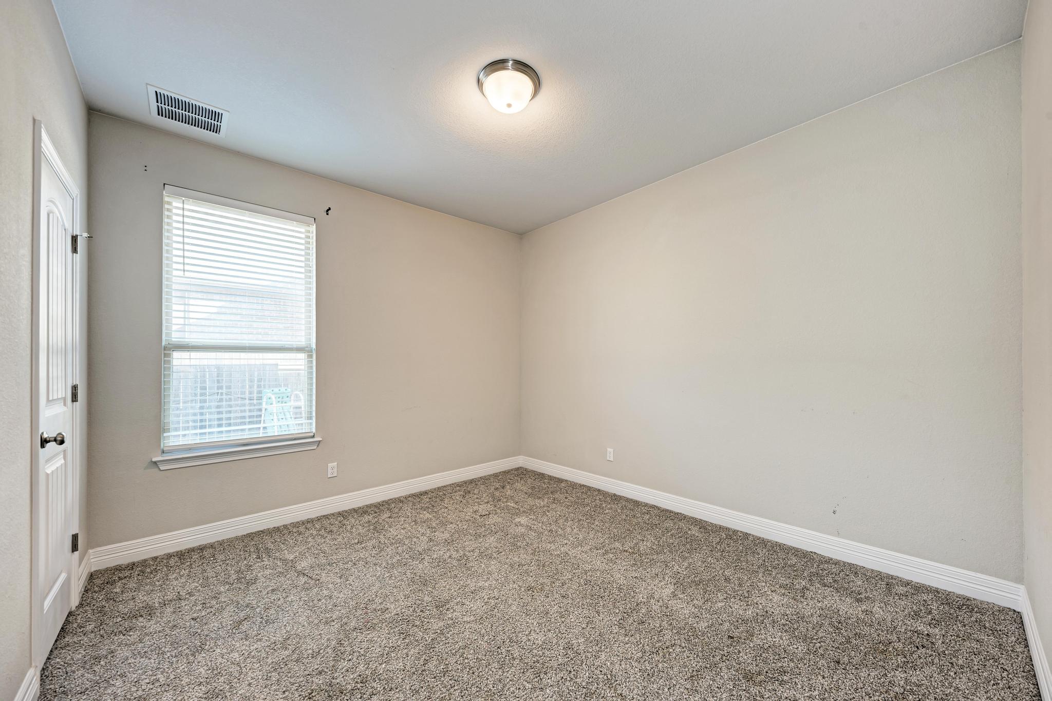 198 Rough Leaf Drive Buda, TX 78610 - Photo 23 of 38 Carpeted spare room with baseboards
