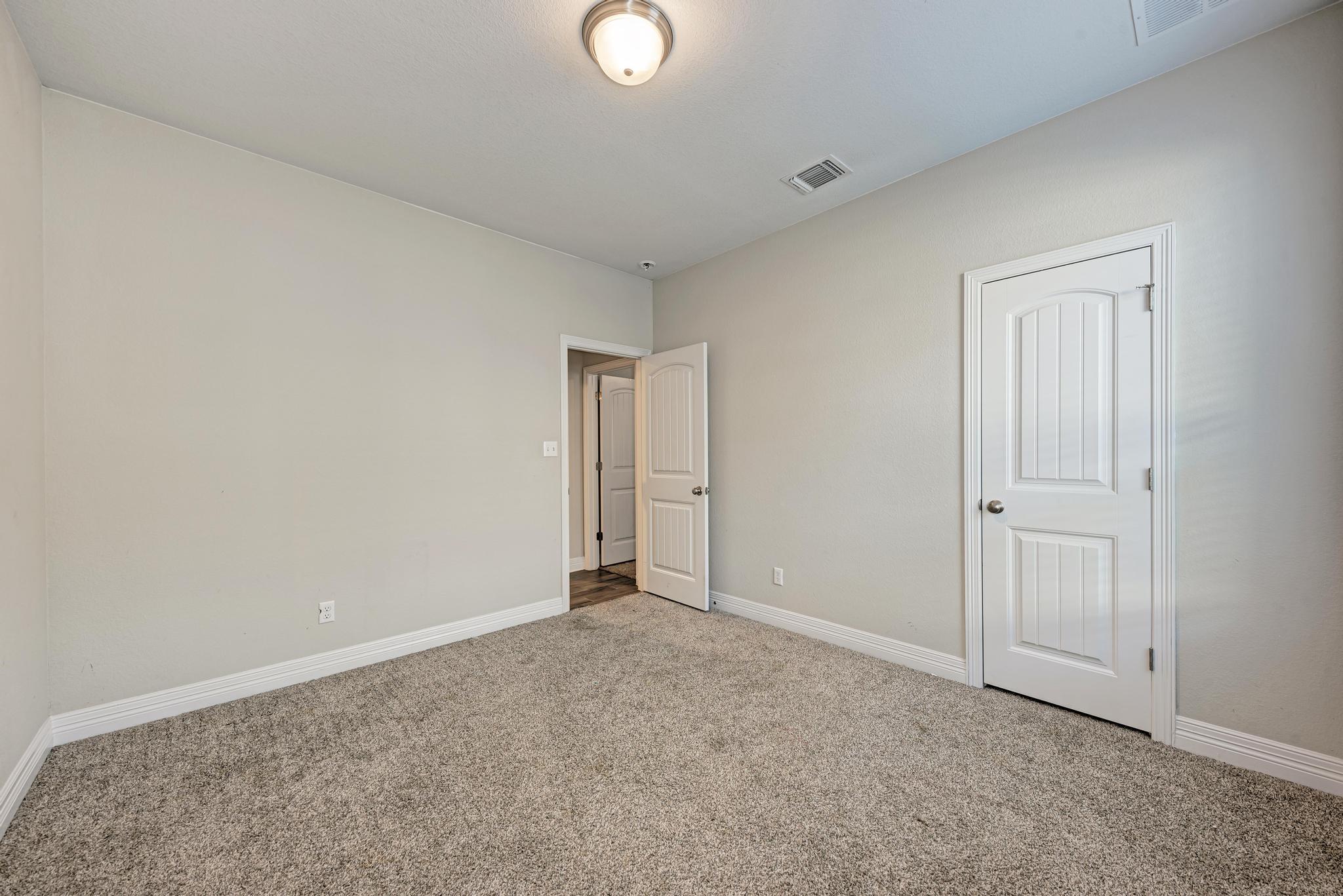 198 Rough Leaf Drive Buda, TX 78610 - Photo 24 of 38 Unfurnished bedroom with baseboards and carpet