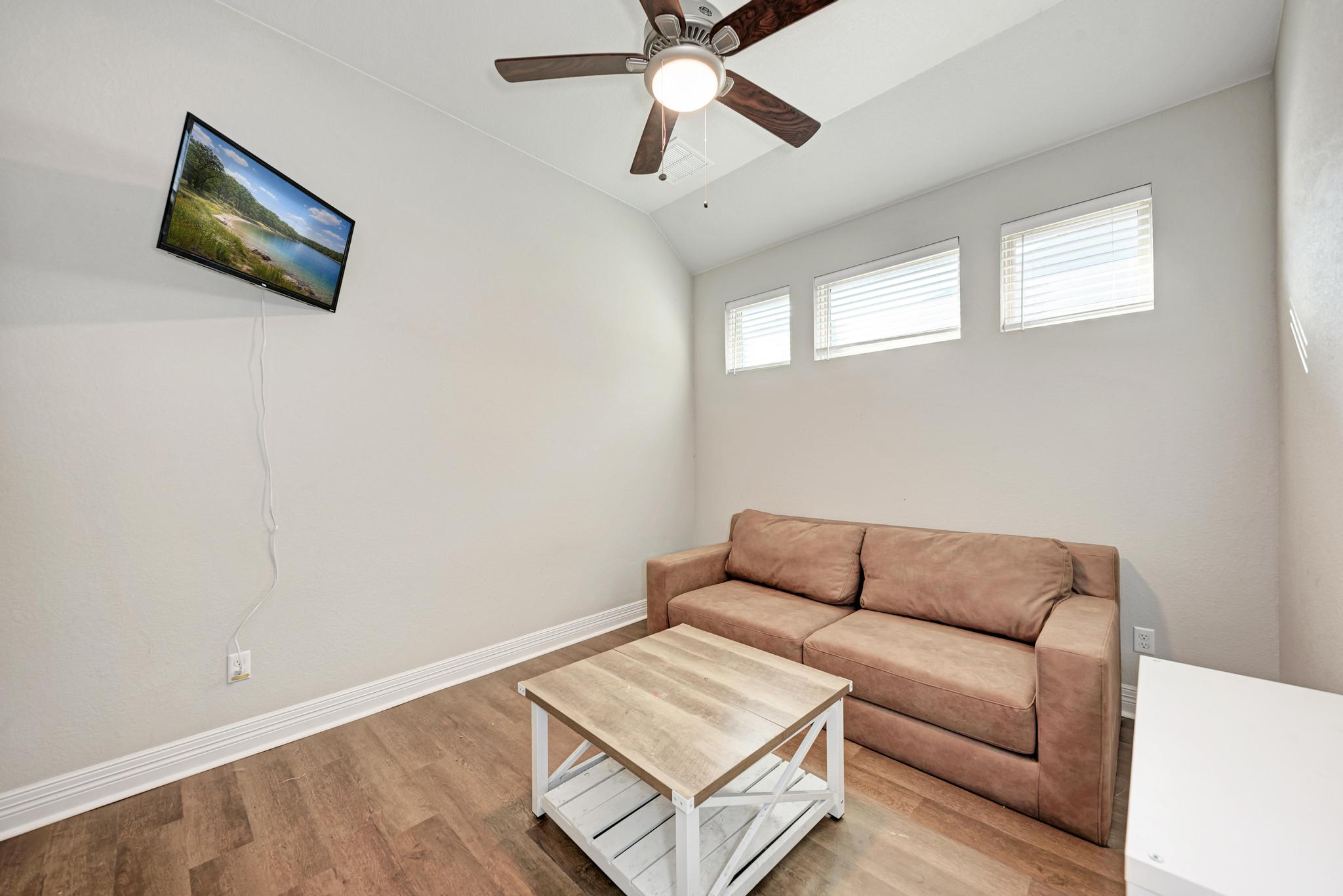 198 Rough Leaf Drive Buda, TX 78610 - Photo 25 of 38 Living area with lofted ceiling, wood finished floors, and ceiling fan