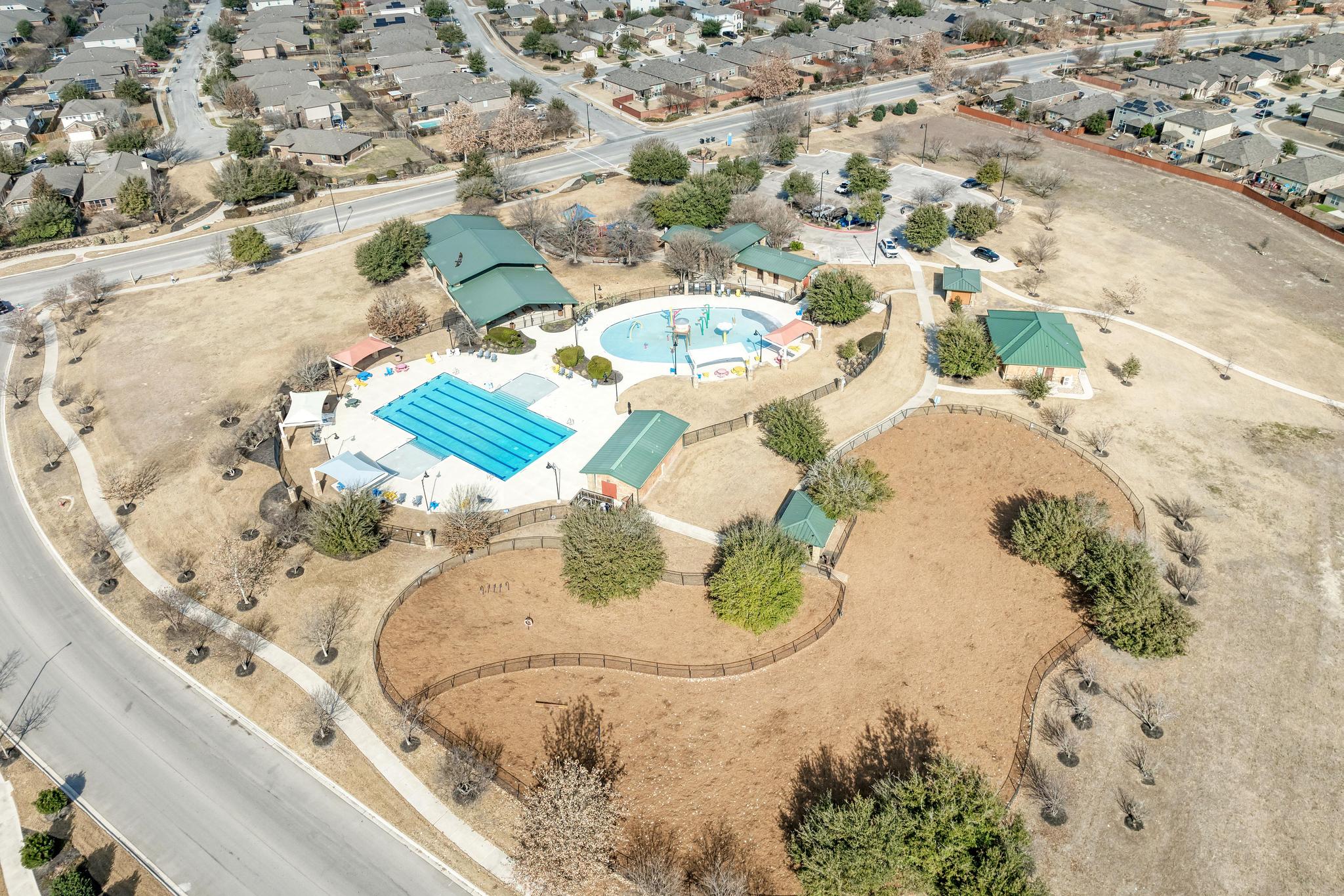 198 Rough Leaf Drive Buda, TX 78610 - Photo 32 of 38 View of property location with a pool and nearby suburban area