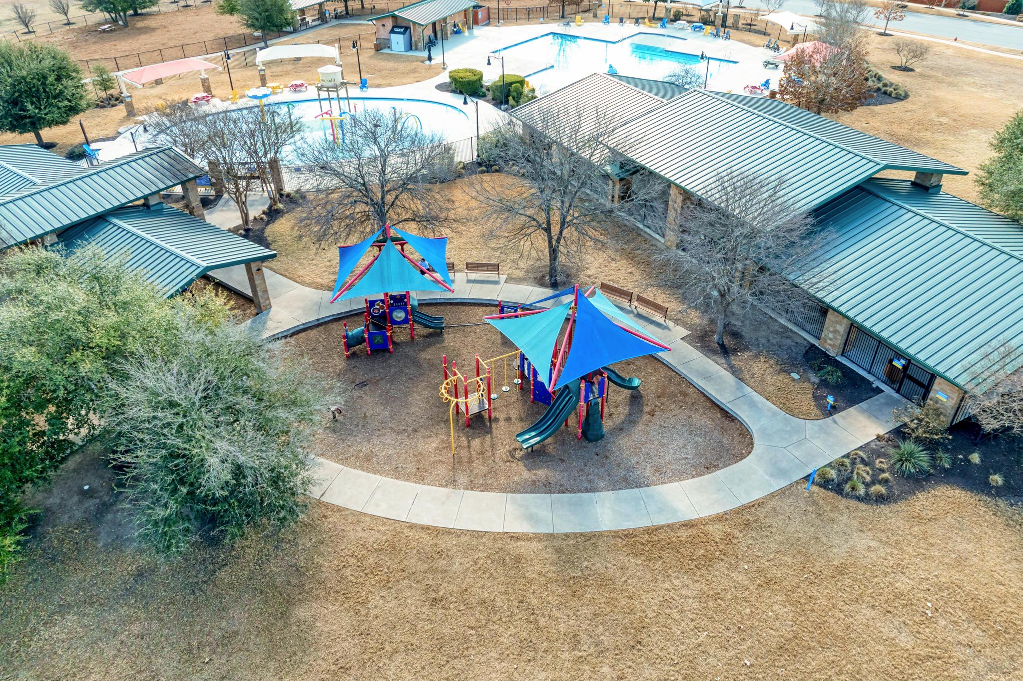 198 Rough Leaf Drive Buda, TX 78610 - Photo 34 of 38 Aerial view of a pool area and a park