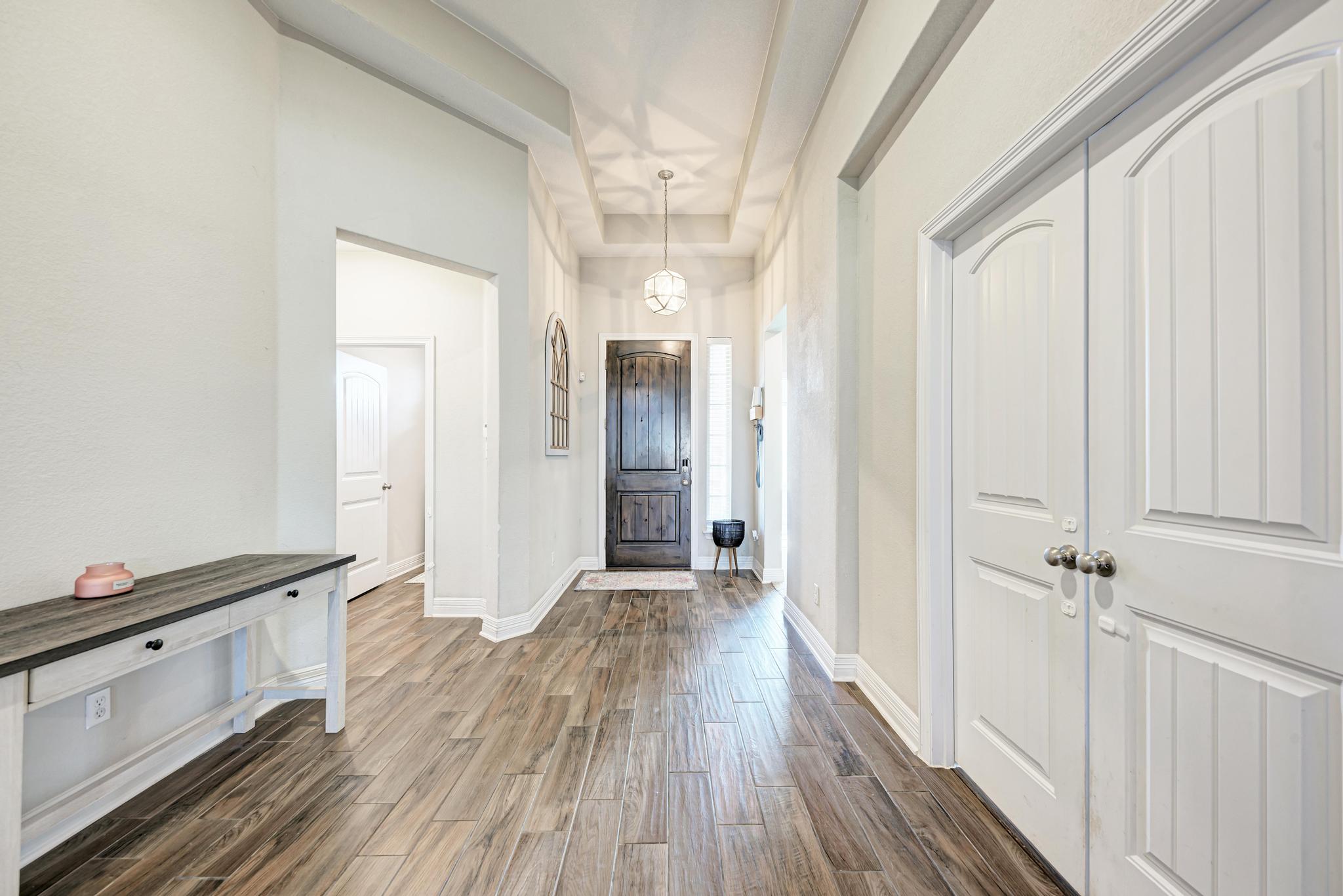 198 Rough Leaf Drive Buda, TX 78610 - Photo 6 of 38 Foyer entrance featuring dark wood-style flooring and baseboards
