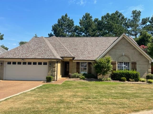 238 Wolf Ridge Cove Collierville, TN 38017 - Photo 1 of 25 a front view of a house with a garden