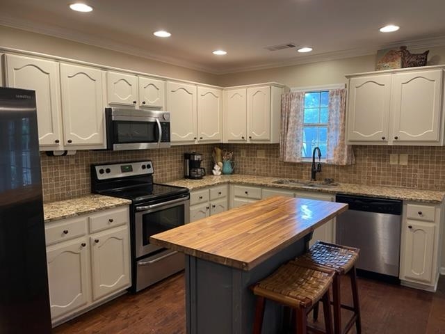238 Wolf Ridge Cove Collierville, TN 38017 - Photo 11 of 25 a kitchen with stainless steel appliances granite countertop a sink a stove a microwave a refrigerator and cabinets