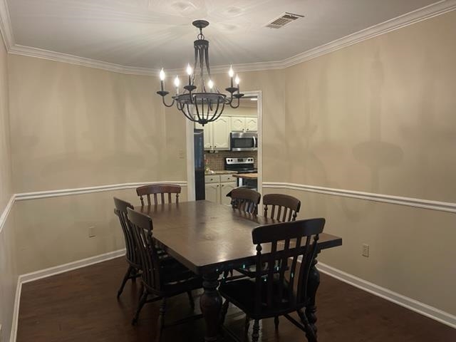 238 Wolf Ridge Cove Collierville, TN 38017 - Photo 13 of 25 a view of a dining room with furniture a chandelier and wooden floor