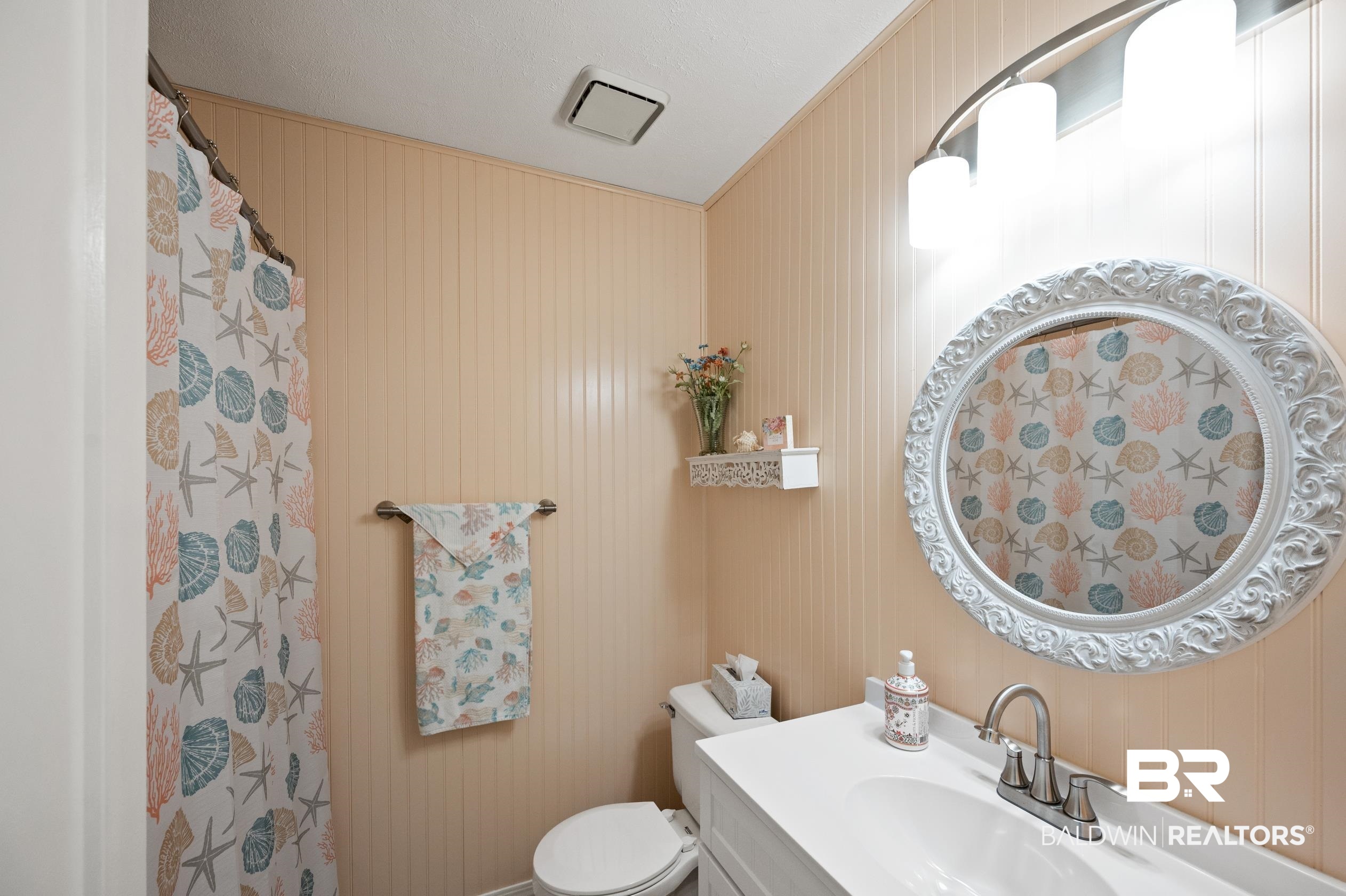 2772 Santa Rosa Circle Lillian, AL 36549 - Photo 23 of 50 Bathroom with wood walls, toilet, and vanity