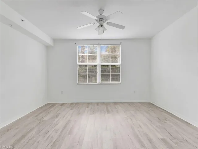 a view of an empty room with a ceiling fan