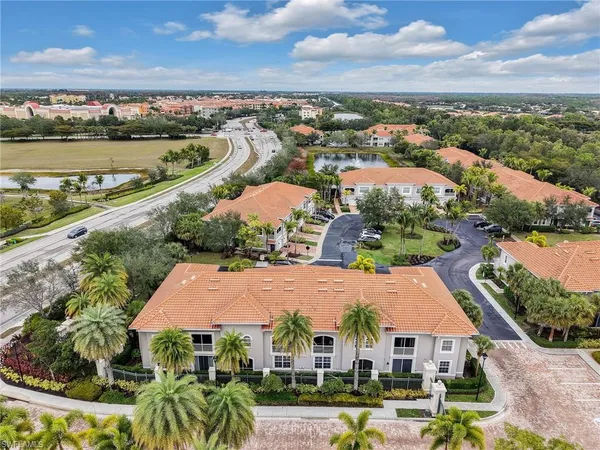 an aerial view of residential houses with outdoor space and river