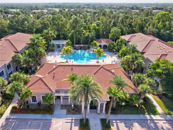 an aerial view of a house with a yard and outdoor seating