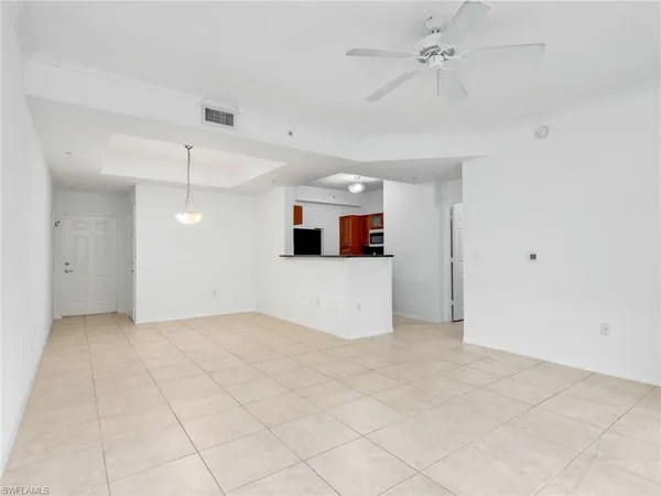 an empty room with closet and windows