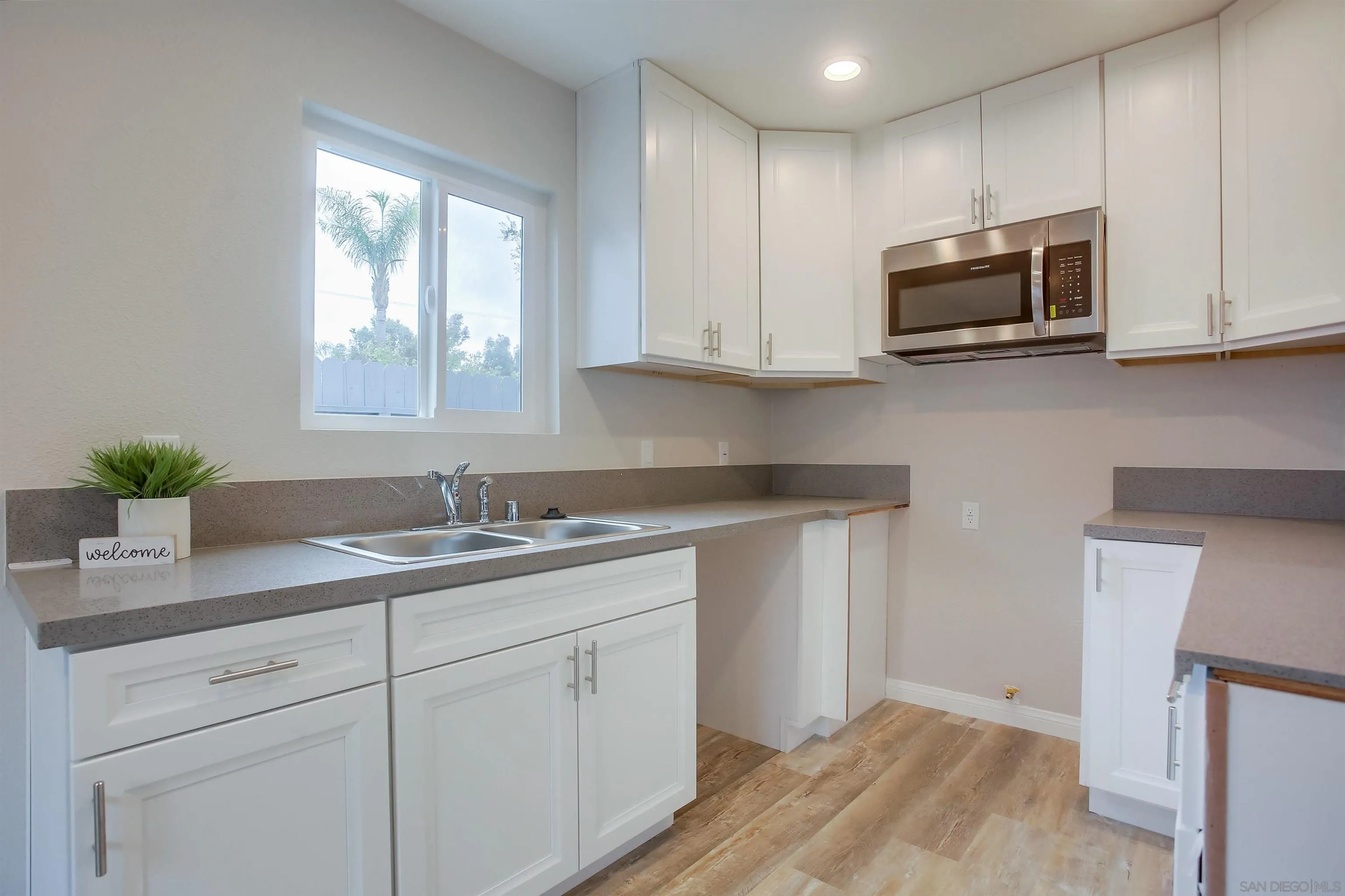 1053 Old Stage Road Fallbrook, CA 92028 - Photo 11 of 21 a kitchen with stainless steel appliances granite countertop white cabinets a sink and dishwasher