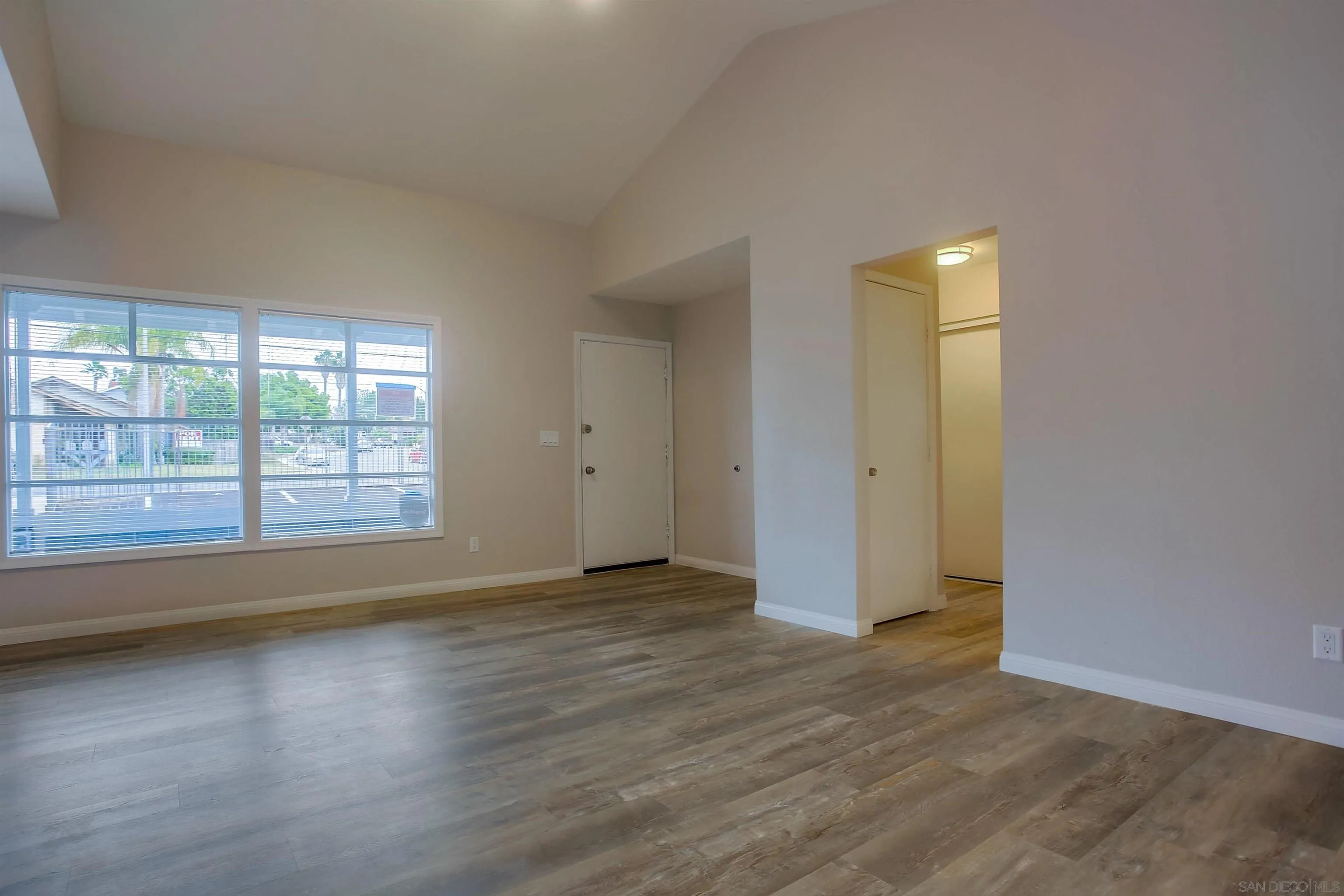 1053 Old Stage Road Fallbrook, CA 92028 - Photo 6 of 21 an empty room with wooden floor and windows