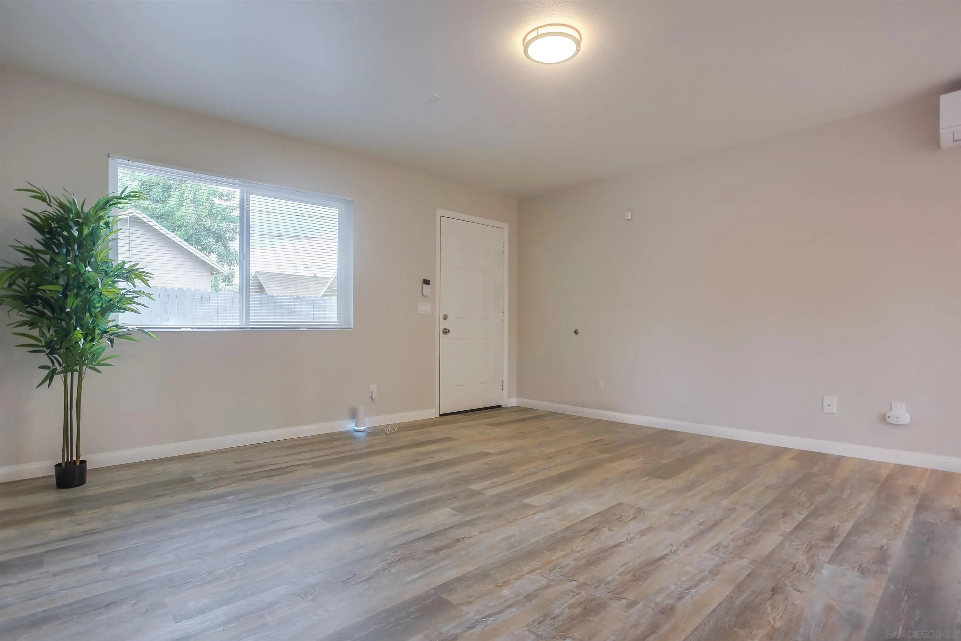 1053 Old Stage Road Fallbrook, CA 92028 - Photo 10 of 21 an empty room with wooden floor and windows