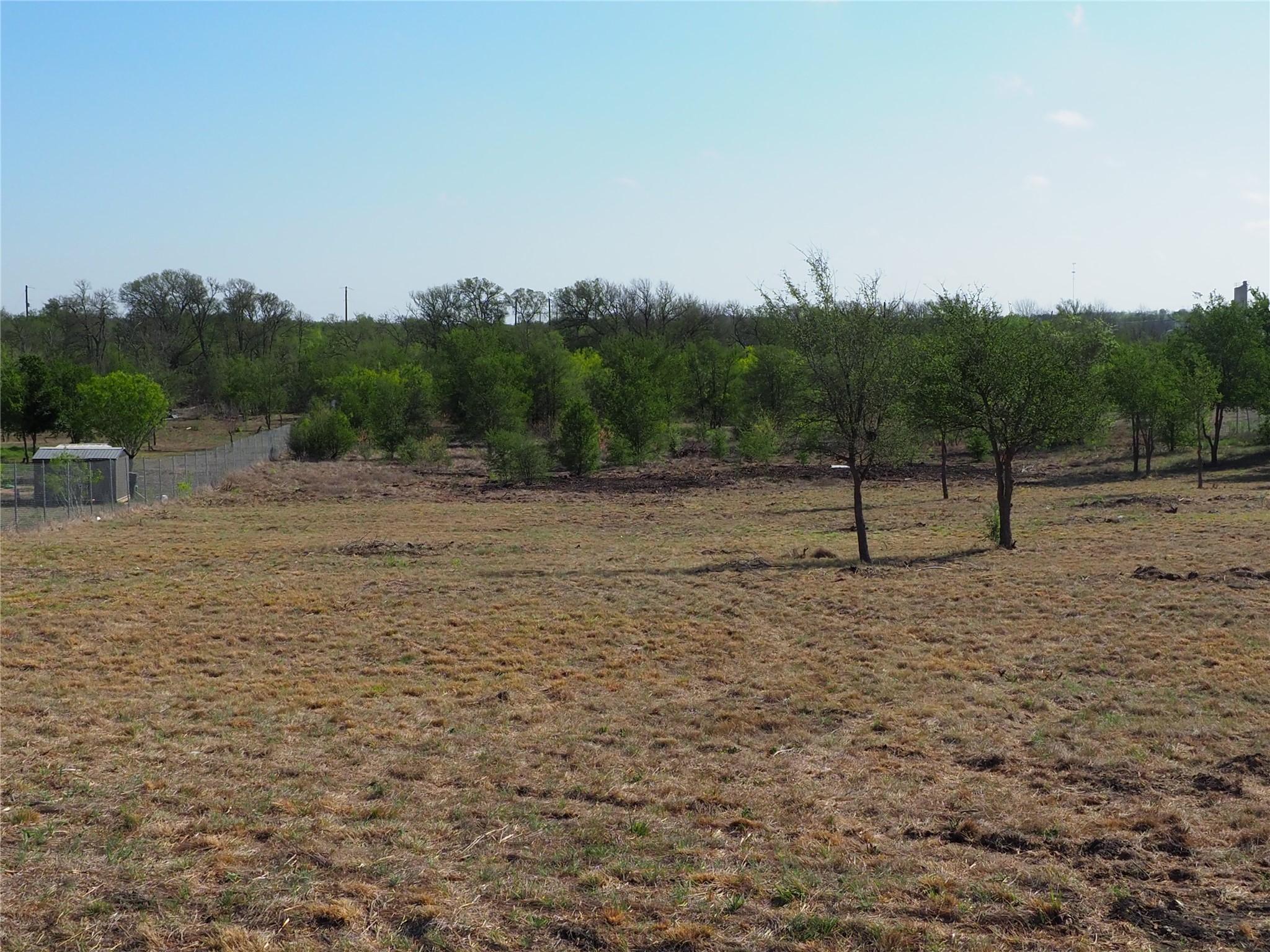 a view of road with trees in the background