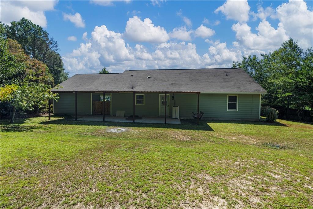 766 Lee Road Phenix City, AL 36870 - Photo 29 of 30 Rear view of house featuring a patio and a yard