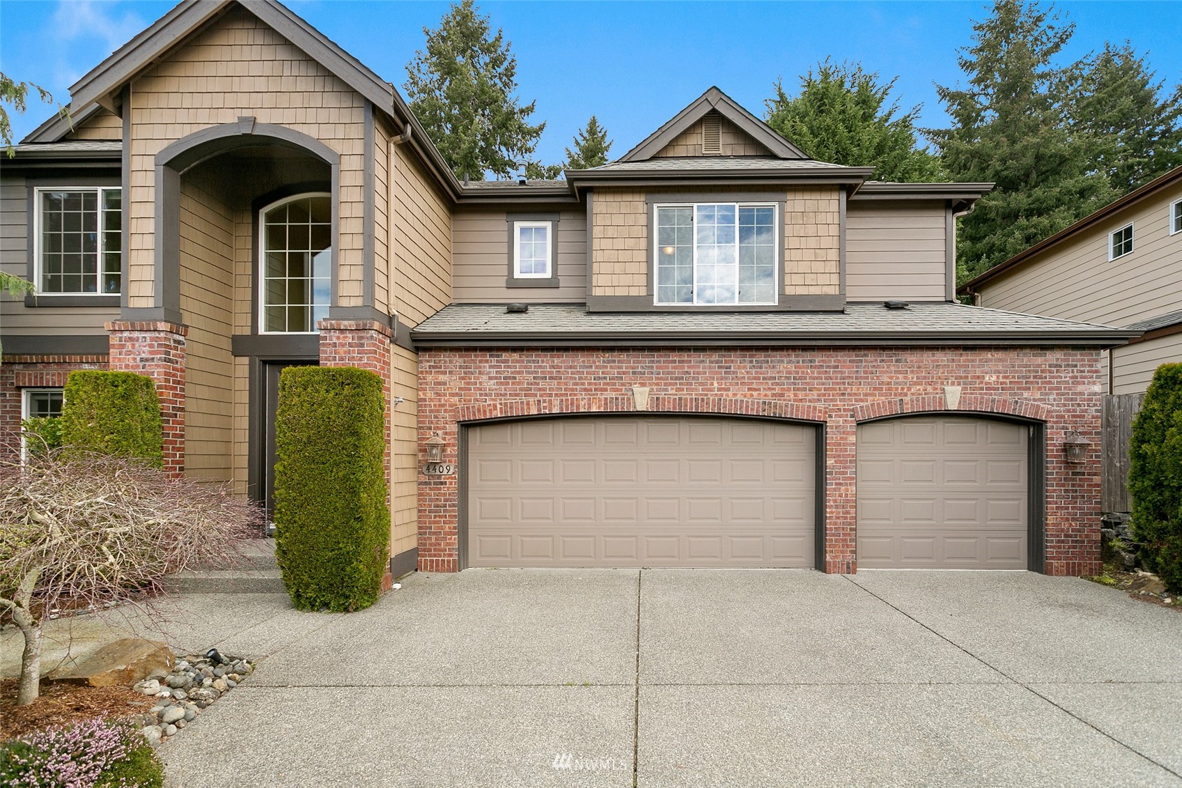 4409 239th Place Southeast Bothell, WA 98021 - Photo 1 of 1 a front view of a house with a garage and a yard